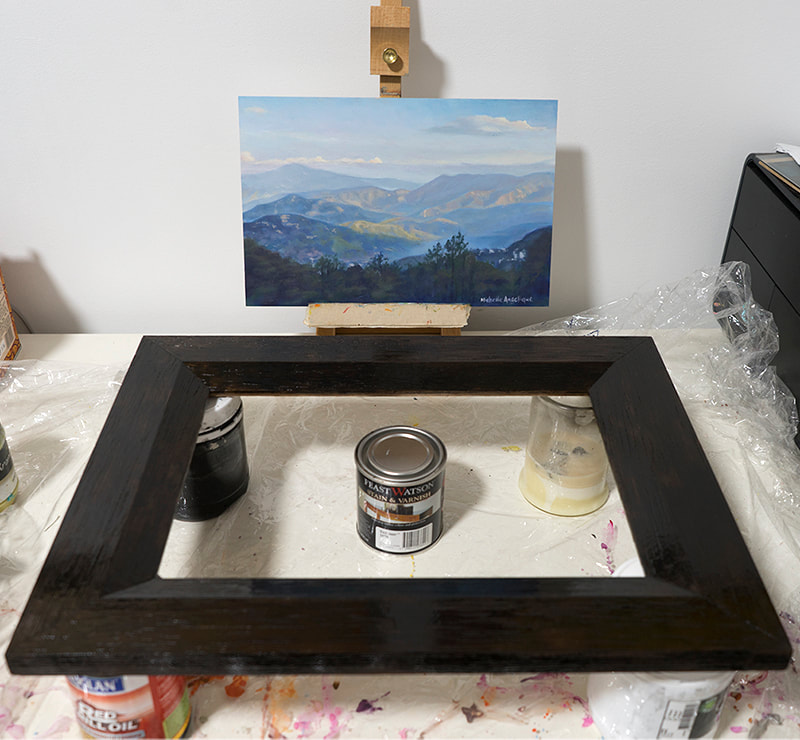 After sanding down the frame, I use a stain/varnish (Feast Watson's Satin Black Japan).